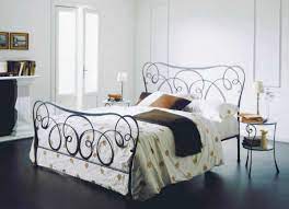 Farmhouse bedroom with faux shiplap, wrought iron bed, grey bedding. Fantastically Hot Wrought Iron Bedroom Furniture