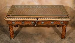 The modus meadow coffee table is the perfect blend of rustic and contemporary styles. Tacked Leather Western Coffee Table