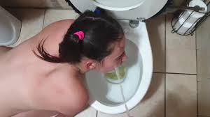 Toilet whore gets slapped and spat on and sucking cock