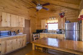 Because of the open floor design of most log and timber homes, the kitchen is visible to family and friends, from other rooms or. Rustic Log Home Cabin Interior With Kitchen And Dining Area Window Fridge Stock Photo 181867344