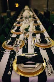 Balloons are a cheap and easy way to decorate, choose black and white ones, add ribbon and bows in the same colors. The Frosted Petticoat Feeding The Soul Gold Party Table Settings Dinner Party