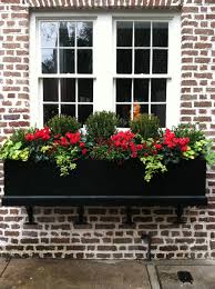 Black planter on the brick wall. 26 Best Window Box Planter Ideas And Designs For 2021