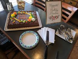The book cake placed on the wooden stand was accompanied by the edible version of the birthday boys other favourite things. We Celebrated My Wife S 60th Birthday Party At Mama Stortini S On Her Request Picture Of Mama Stortini S Puyallup Tripadvisor