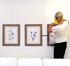 Here S How To Hang 3 Frames Above A Sofa Without Messing Your Walls It S Easier Than You Think Wall Behind Couch Hanging Pictures On The Wall Wall Behind Sofa