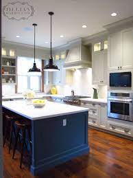 In this spanish style home, seafoam base cabinets and white wall cabinets are unified with brass hardware. Jillian Harris Pne Prize Home Kitchen Jillianharris Kitchen Homedecor Kitchen Island Cabinets Kitchen Design Kitchen Cabinets Color Combination