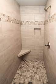 Beige Tiled Shower With Accent Tile Floor And Stripe Tile Shower Niche Shower Tile Bathroom Shower Tile