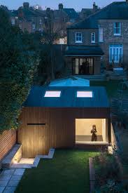 Eastwest Architecture Has Sunken A Compact Gym Into The Garden Of A London Home Featuring Bright Birch Lined Interior Architecture Garden Cabins Garden Studio