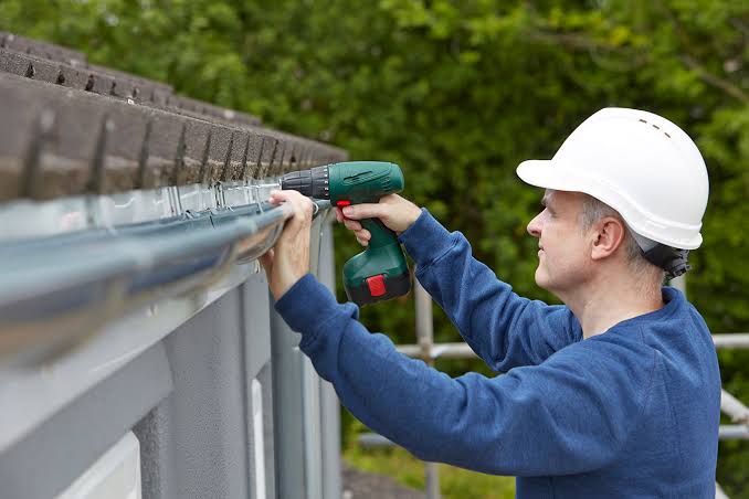 Downspout extension directing rainwater away from a house