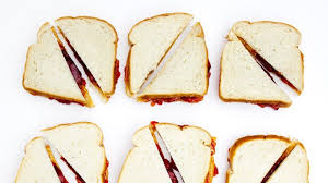 Child eating messy peanut butter and jelly sandwich with milk and fruit for healthy lunch. How To Make A Better Peanut Butter And Jelly Sandwich Bon Appetit