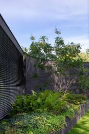 Red brick houses with black trim. This Home Combines A Black Brick Exterior With Large Glass Walls For A Strong Contemporary Design