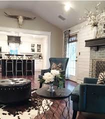 Farmhouse Great Room With Modern Design Elements Gold Accents Rustic Wood Mantle Shiplap C Cowhide Rug Living Room Farm House Living Room Cowhide Living Room