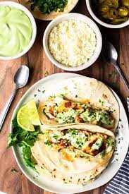 These blackened tilapia fish tacos are served with a creamy spicy sriracha mayo and are absolutely delicious. Blackened Fish Tacos Delicious Little Bites
