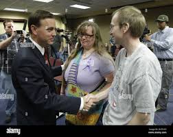 West Valley City Mayor Mike Winder, left, hands with John and Kiirsi  Hellewell, friends of Susan Powell, following a news conference Monday, May  20, 2013, in West Valley City, Utah. Citing a