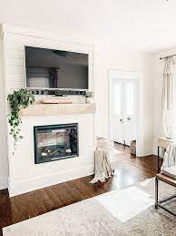 Cut three poplar boards to size to form the vertical pilasters and horizontal frieze of the fireplace mantel. Diy Shiplap Electric Fireplace Mantel Micheala Diane Designs