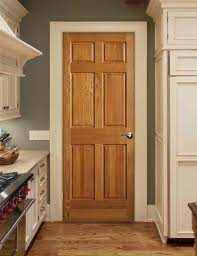 House with white stucco exterior and arched doorways and windows facing the driveway. Natural Wood Doors With White Trim Novocom Top