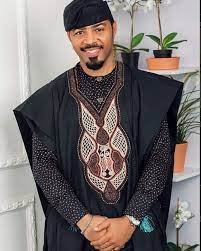 He worked a classic white shirt and white trousers and the agbada design consist of blue embroidery on a white background. Ramsey Nouah In Black Embroidered Agbada Clipkulture