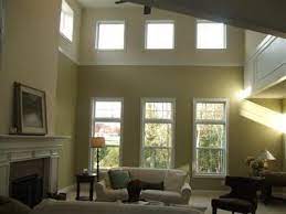 The weighty topper highlights a beadboard ceiling chosen for its vintage cues. Trim Work To Break Up Tall Walls And Define Space High Ceiling Living Room Living Room Wall Crown Molding Vaulted Ceiling