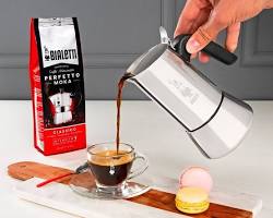 Image of Bialetti Venus Induction with a cup of espresso