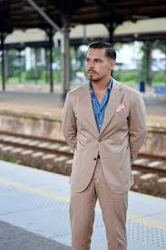 Dark blue denim shirt and floral mini skirt with a coral necklace: How To Style A Denim Shirt Men S Outfit Ideas For Jean Shirts