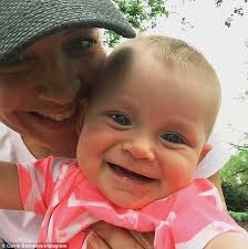 Carrie Bickmore cradles her baby daughter Evie in Melbourne