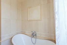 16 beige and cream bathroom design ideas | house and decoration source. Classic Bathroom In Beige Tones Curved Bath Tub Large Beige Tile White Tiles On The Floor Twisted Chandelier Stock Photo Image Of Royal Bathroom 172650664