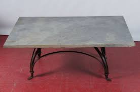 The subtle and elegant dark gray finish combined with the durable metal construction of this coffee table makes it a bargain. Wrought Iron And Stone Garden Coffee Table For Sale At 1stdibs