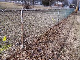 Plumb the posts and fill the holes with concrete. Ugly Chain Link Fence Can Ruin A Careful Landscape