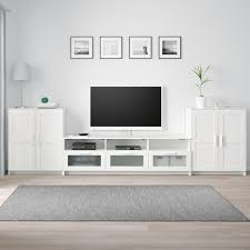 You can run the plug to the socket through the backside. Brimnes Tv Storage Combination White Ikea