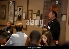 Mr. Paul Chapa, founder of Food Industry Feeding Heroes (FISH) speaks with  honored guests after the FISH dinner, at Iron Mike's lounge