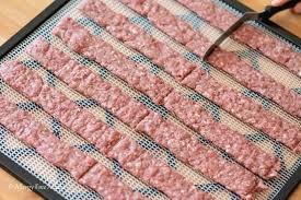 Next, add the teriyaki marinade, honey, soy sauce, orange juice, liquid smoke, and water. Ground Beef Jerky