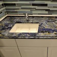 Green granite countertops can work well with white cabinets and shiny hardware for a fresh, inviting look. Take It For Granite True Blue Granite Slabs Msi Blog