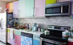 A Kitchen With Multicoloured Doors And A White Worktop Multicoloured Kitchens Kitchen Cabinets White Worktop