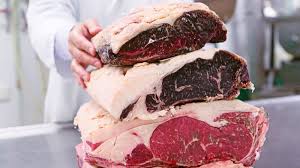 Dry aging is the process in which beef is aged in a temperature controlled environment for a specific length of time before it is trimmed and then cut into steaks. Dry Aged Beef Wikimeat
