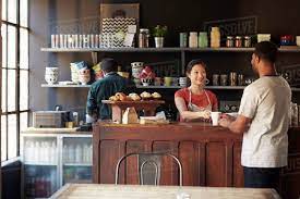 Coffee shop at cool math games: Staff Serving Customer In Busy Coffee Shop Stock Photo Dissolve