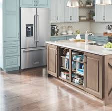 The white tile backsplash and gray cork flooring add layers of neutrals. Kitchen Cabinet Buying Guide