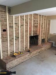 A fireplace insert can transform your existing fireplace into a super efficient heater. Tired Of Your Brick Fireplace Transform Your Den Into The Modern Living Room Yo Best Pin