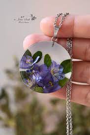 After they dried, put them into the silicone molds and pour the resin over them. Pendant With Real Flowers In Resin Blue Flowers Necklace Medallion With Blue Flowers Flower Resin Jewelry Resin Jewelry Resin Pendant Necklace