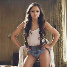 Full body portrait of Jenna Ortega as a farmer wearing a  blackgartersuspenderharnessmicro