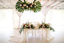 Tropical Theme Wedding Reception Decor With Monstera Leaves Pineapple Centrepieces Greenery An Tropical Wedding Theme Tropical Wedding Decor Tropical Wedding