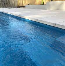 Hard, dense pavers efficiently soak up the energy from the sun. Dropdown Dropface Pool Coping Using Porcelain Pavers Narellanpools Dropfacecoping Porcelaintiles Ambertilesseafor Stone Pool Deck Pool Coping Pool Pavers