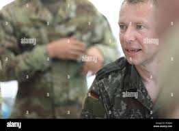 German Liaison Officer Lt. Col. Markus Stobbe of the U.S. Special  Operations Command explains the guidelines of the German Armed Forces  Proficiency Badge swimming event at the 2018 U.S. Army Reserve Best