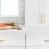 White shaker cabinets with black hardware. 1
