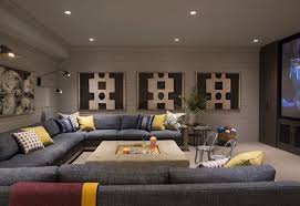 Basement Media Room With Large Sectional Ottoman With Tray Carpet Flooring And Shiplap Wall Paneling Interior Design Large Family Rooms Media Room Design