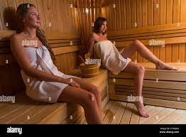 Two beautiful sexy semi-nude young women relaxing sauna Stock Photo - Alamy