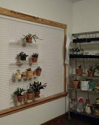 Hanging Window Plant Shelves By Beautiful Views Faq A metal planter in a primitive shape sits your plant high or low.