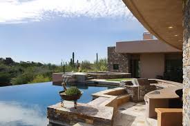 Modern Swimming Pool With Exterior Stone Floors Infinity Pool Pool With Hot Tub Outdoor Kitchen Fire Pit Swimming Pools Exterior Stone Stone Flooring