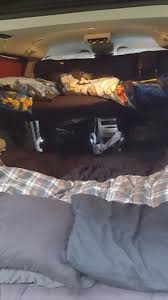 Double Decker Sleeping In A Dodge Grand Caravan Mini Van Camping The Bunk Bed Sits On The Sliding Doors With The Stowaway Seats Van Camping Bed Pillows Home