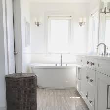 Ready to give your bathroom the stylish design it deserves? Wood Like Bathroom Floor Tiles With Oval Freestanding Tub Modern Bathroom