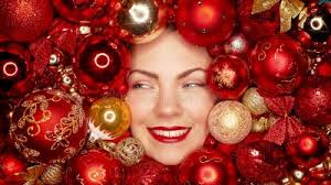 Happy Woman Face Lights Up with Joy in Red Christmas Tree Toys Balls.  Holidays. Stock Video