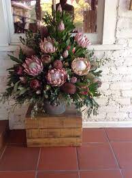 Feature Arrangement Of King Protea Banksia And Pink Ice Church Flower Arrangements Large Flower Arrangements Flower Arrangements